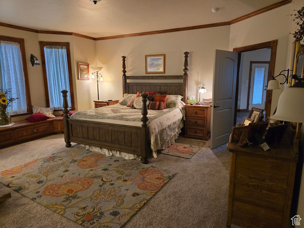 Bedroom with carpet flooring and ornamental molding