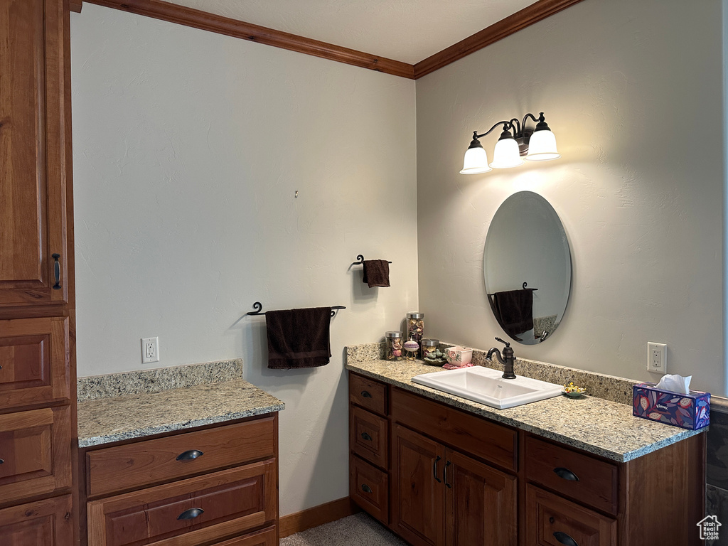 Bathroom featuring vanity and ornamental molding