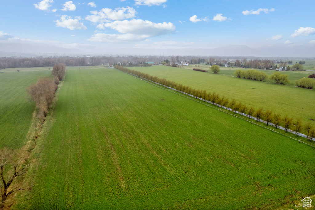 Overview of rural landscape featuring extensive farmland and mountains