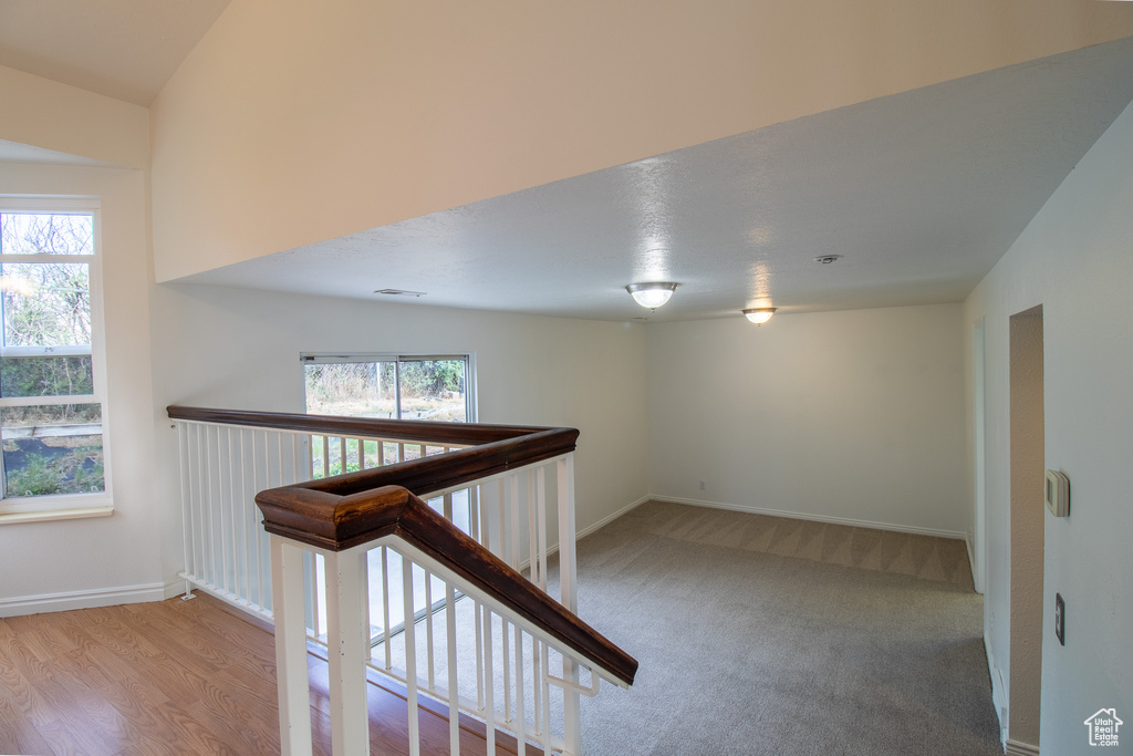 Hallway featuring an upstairs landing and baseboards