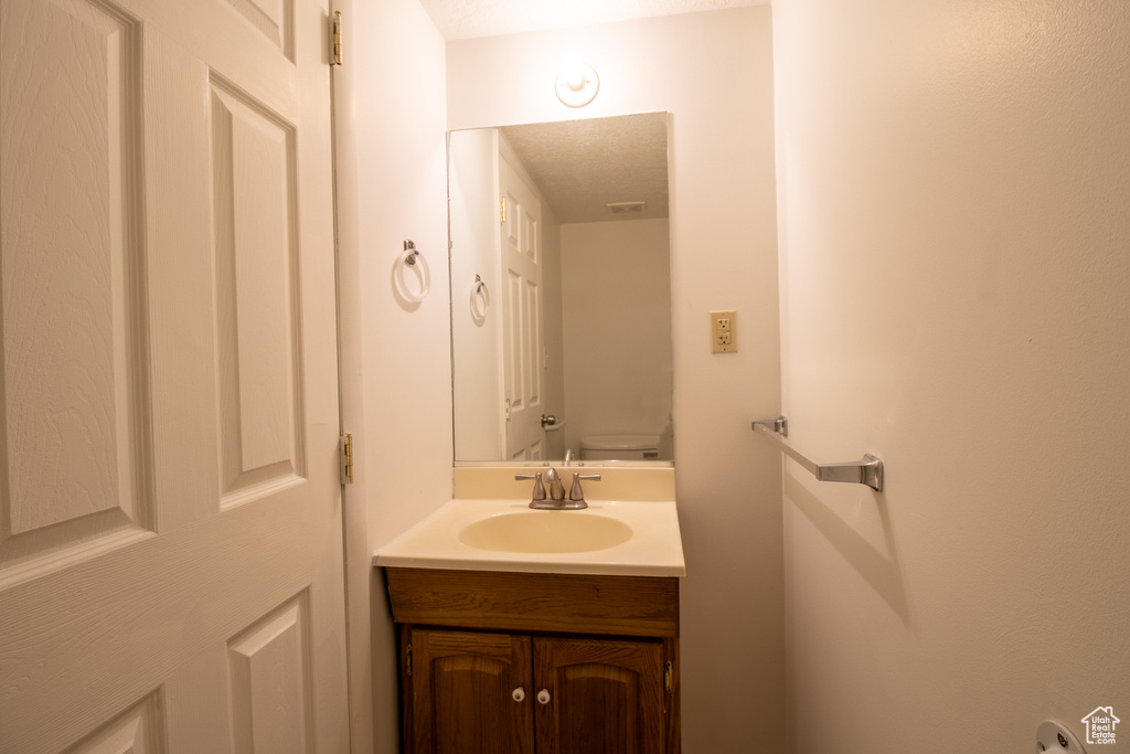 Bathroom featuring vanity and toilet