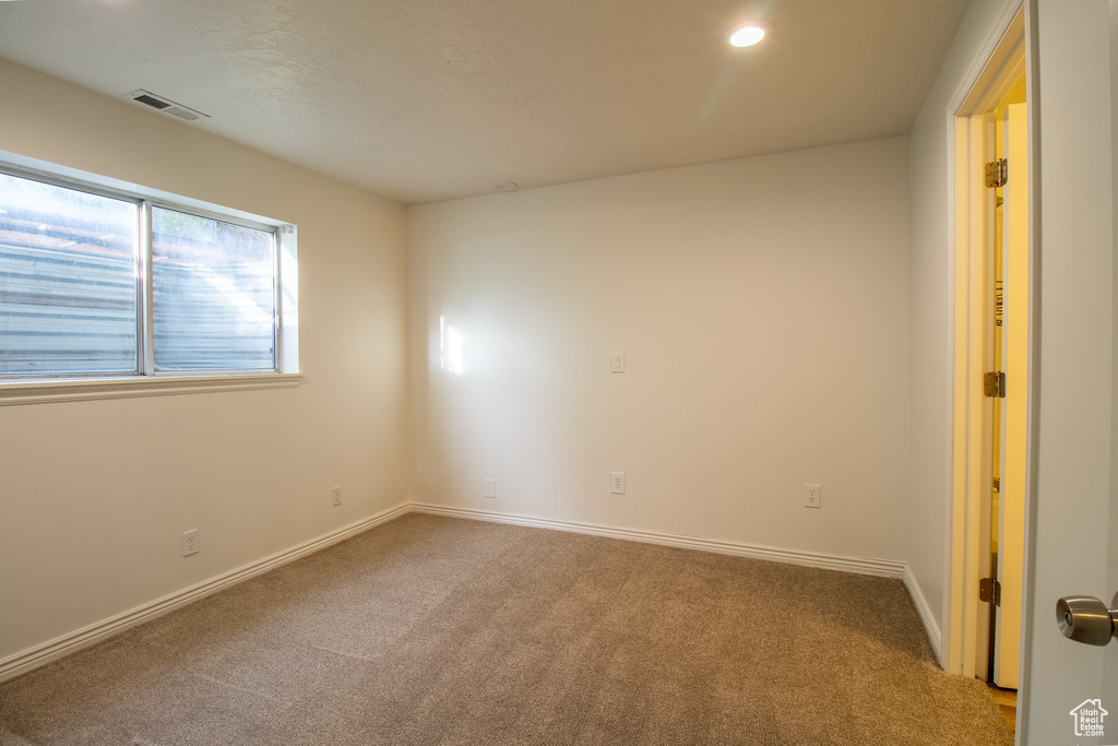 Empty room with carpet flooring, baseboards, and recessed lighting