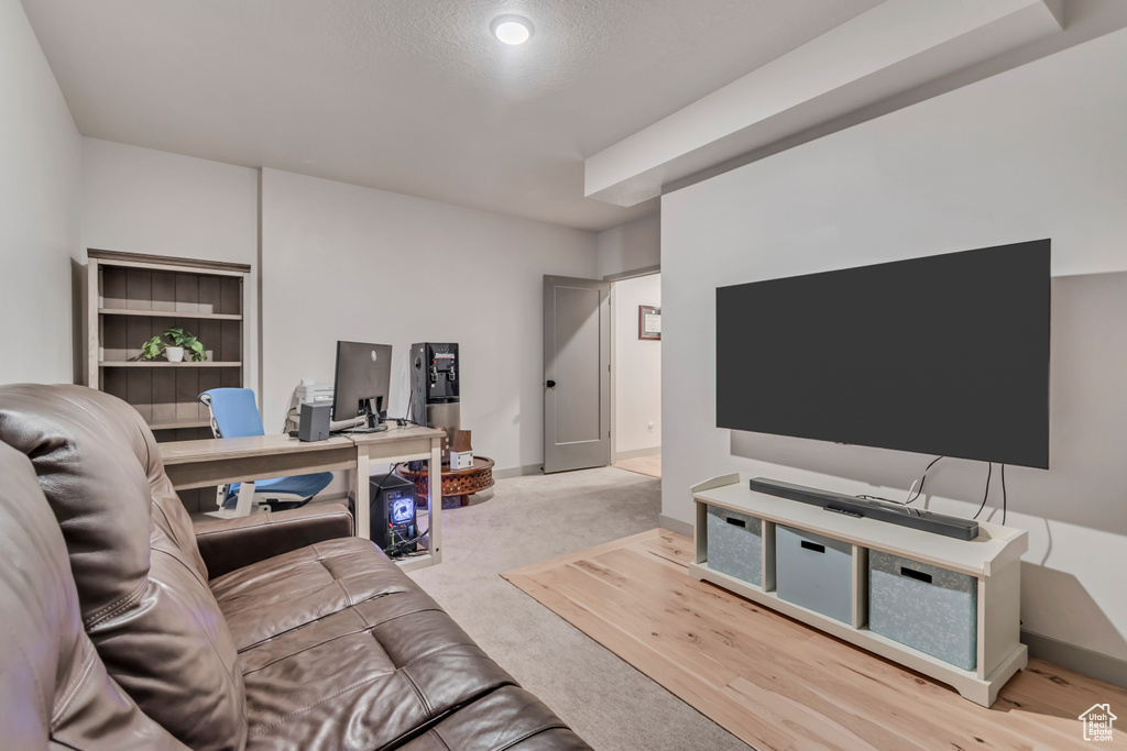 Living room with carpet floors and an office area