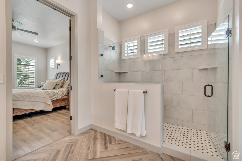 Ensuite bathroom with a tile shower, a ceiling fan, and recessed lighting