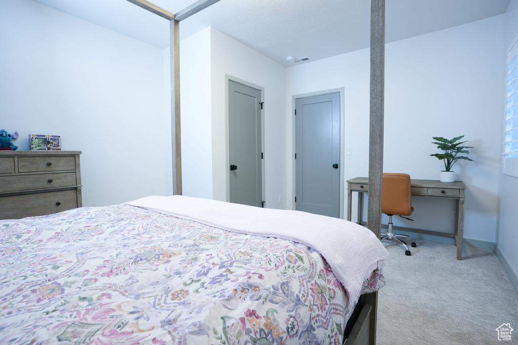 Bedroom with carpet flooring and baseboards
