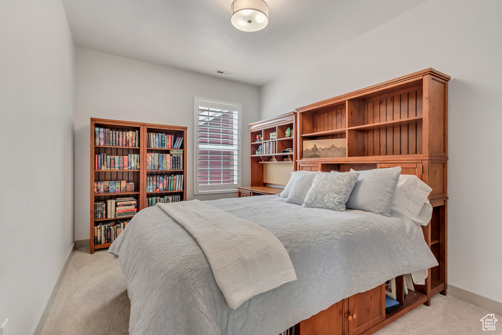 Bedroom with light colored carpet