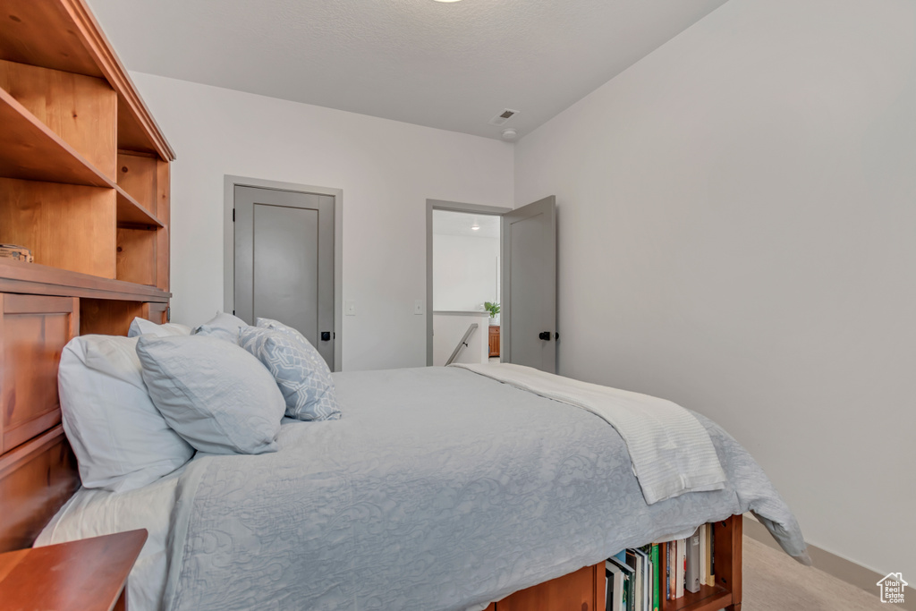 Bedroom with light colored carpet