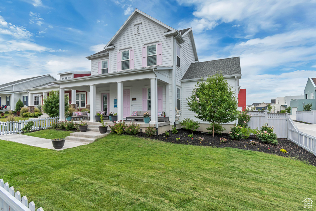 View of front of property with a fenced backyard and a shingled roof