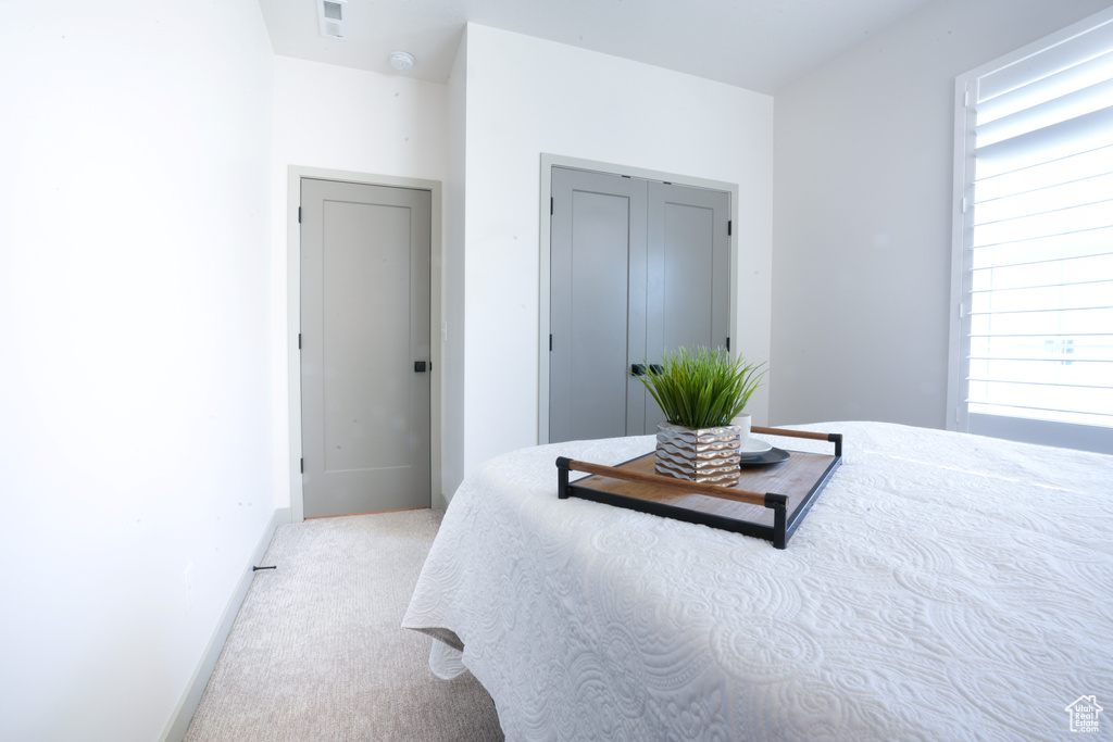 Carpeted bedroom featuring baseboards