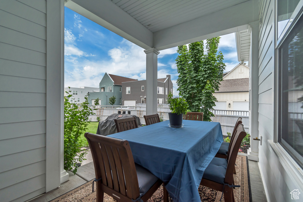 View of patio / terrace featuring outdoor dining space and a residential view