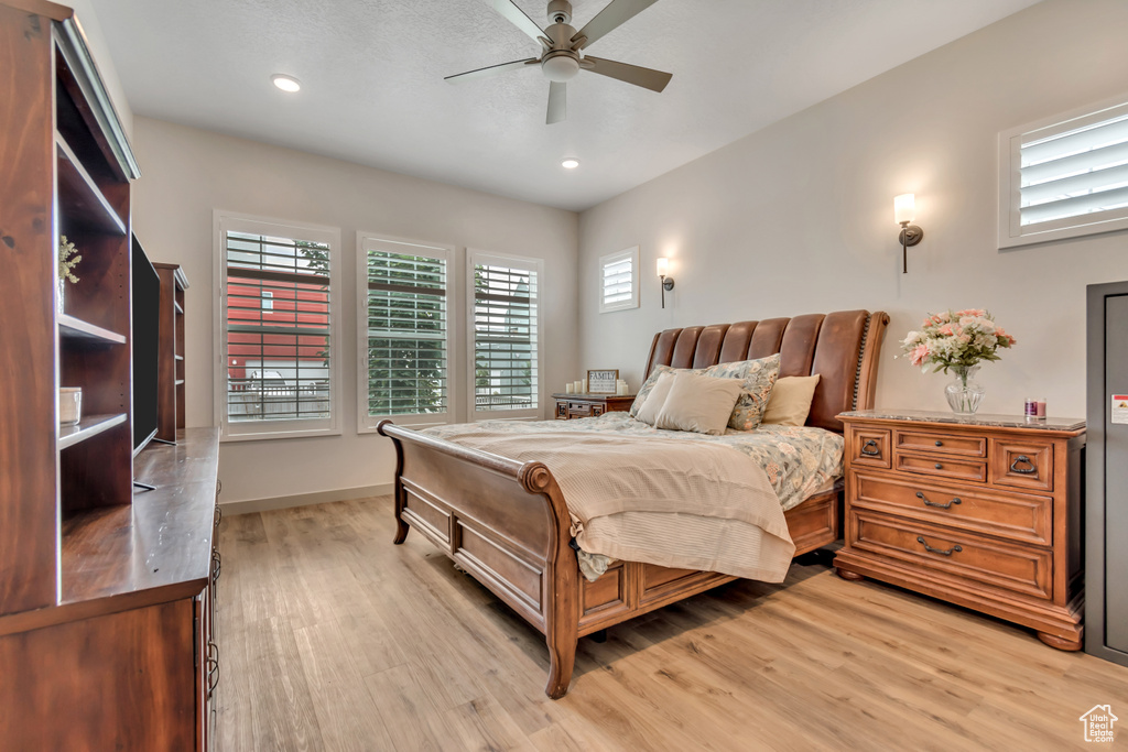 Bedroom with light wood-style floors, recessed lighting, and a ceiling fan