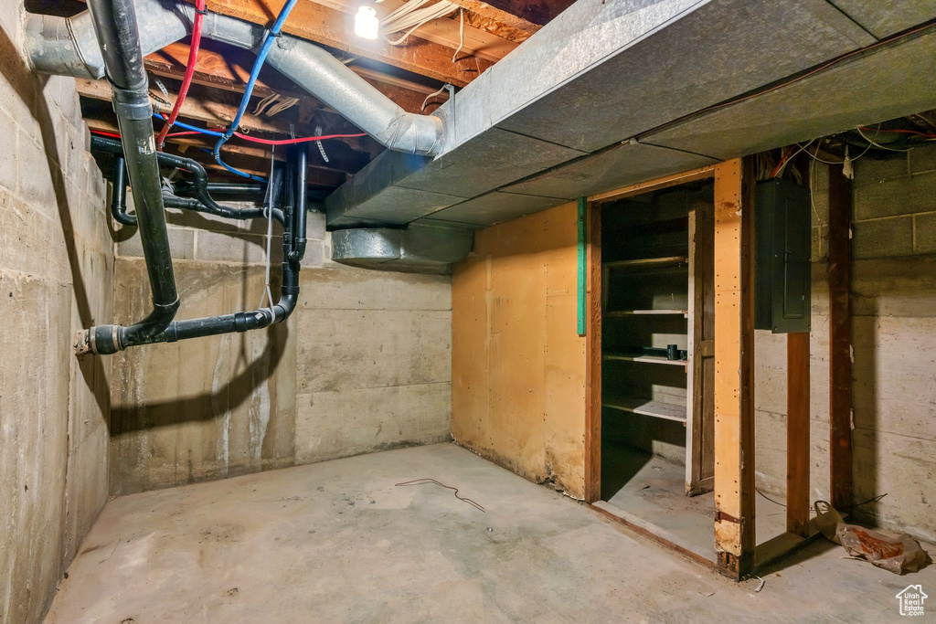 Unfinished below grade area featuring electric panel