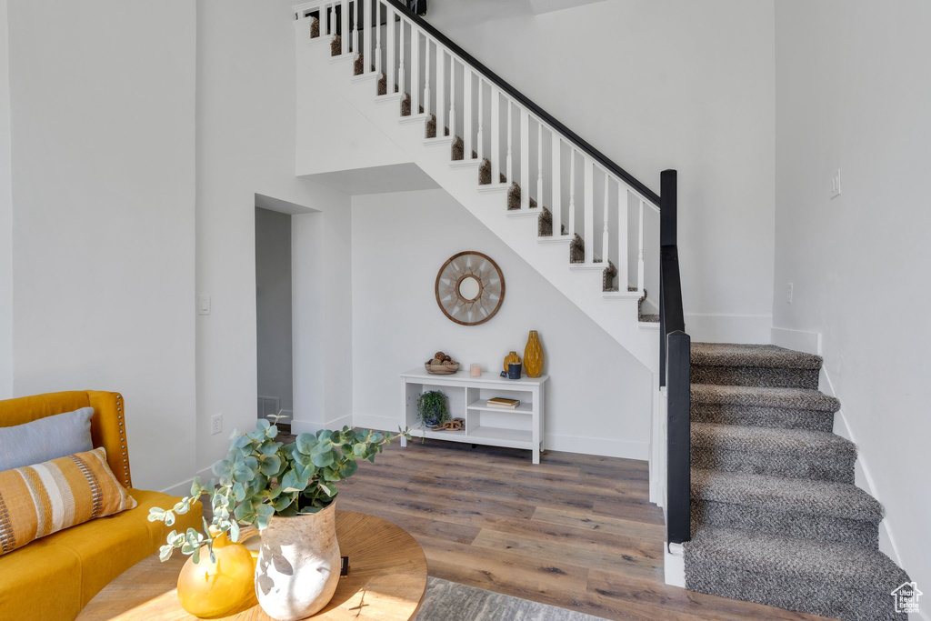Staircase featuring wood finished floors and baseboards