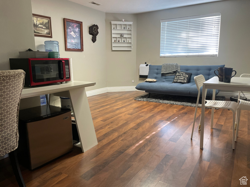 Living area with wood finished floors and baseboards