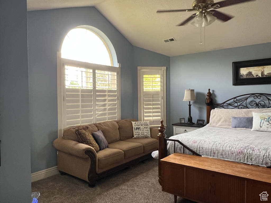 Bedroom featuring vaulted ceiling, carpet floors, and a ceiling fan