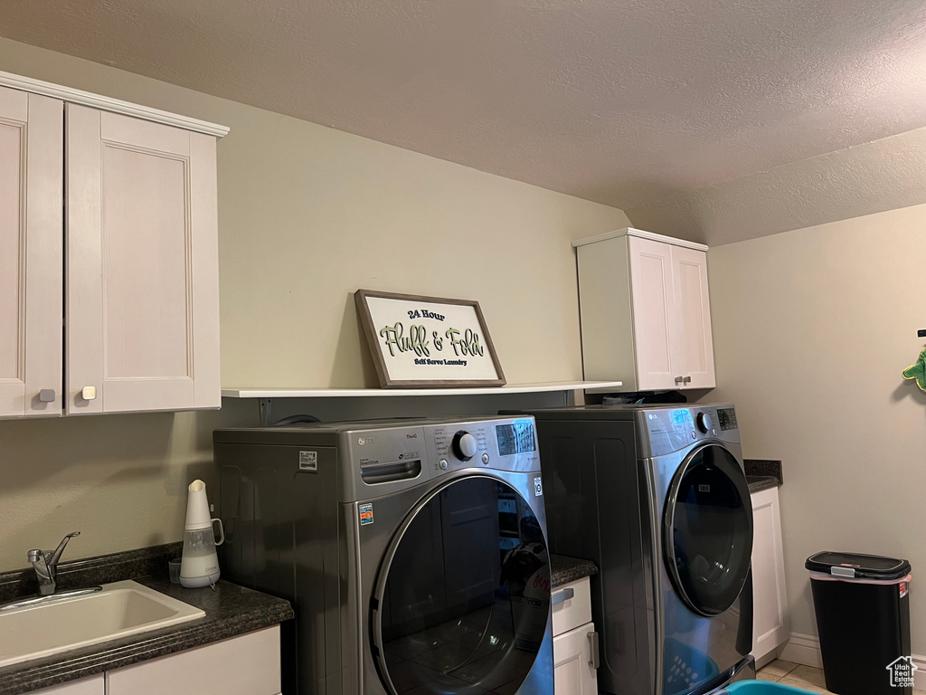 Washroom with cabinet space and washer and clothes dryer
