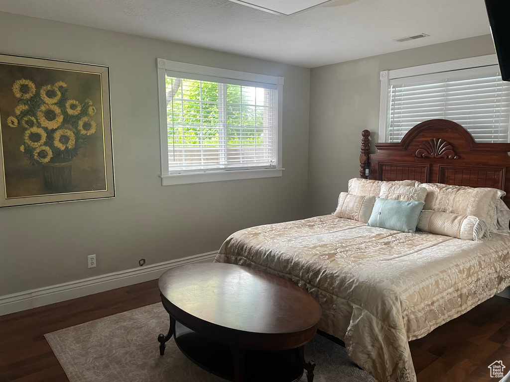 Bedroom featuring wood finished floors and baseboards