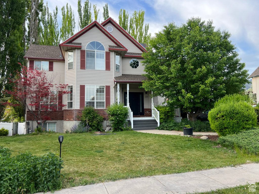 Victorian-style house with brick siding