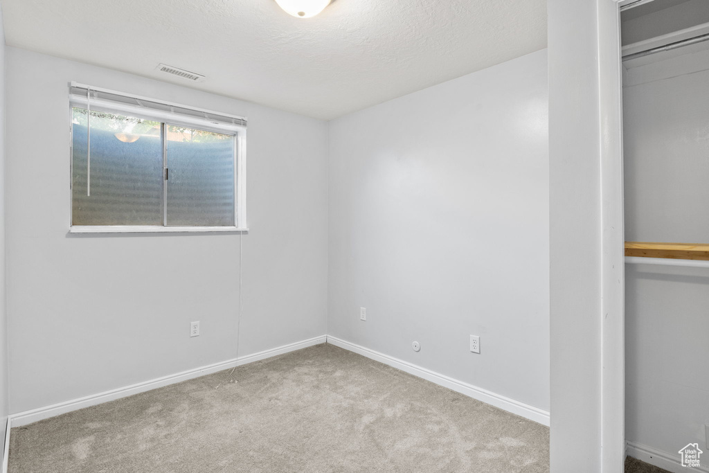 Unfurnished bedroom with carpet floors and baseboards