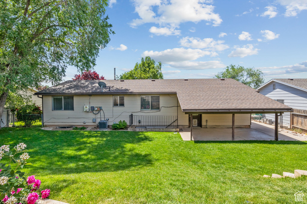 Rear view of property with a patio area, central AC, and roof with shingles