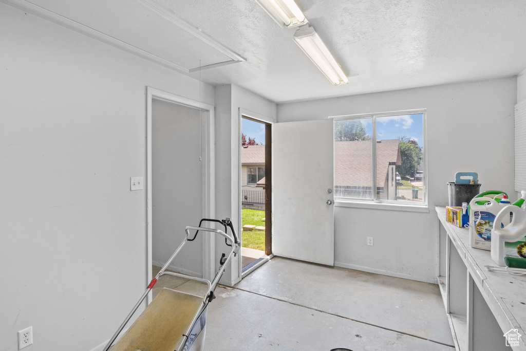 Interior space featuring attic access and baseboards