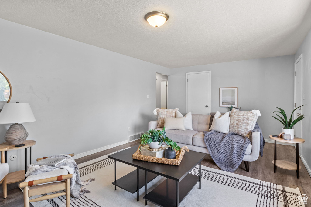 Living room with wood finished floors and baseboards