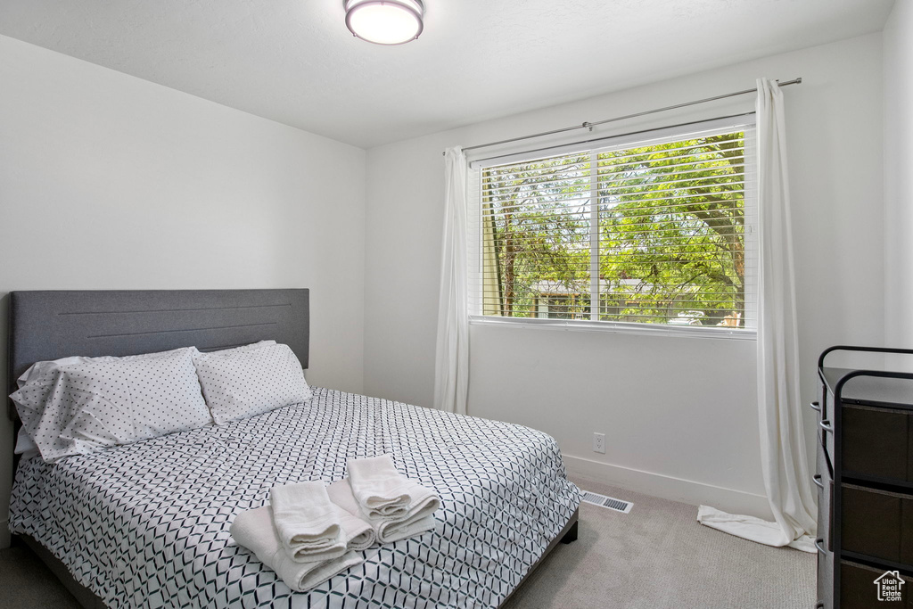 Bedroom with carpet flooring and baseboards