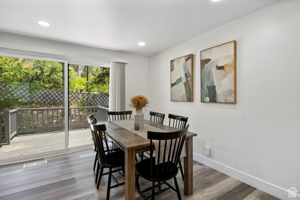 Dining space featuring wood finished floors, baseboards, and recessed lighting