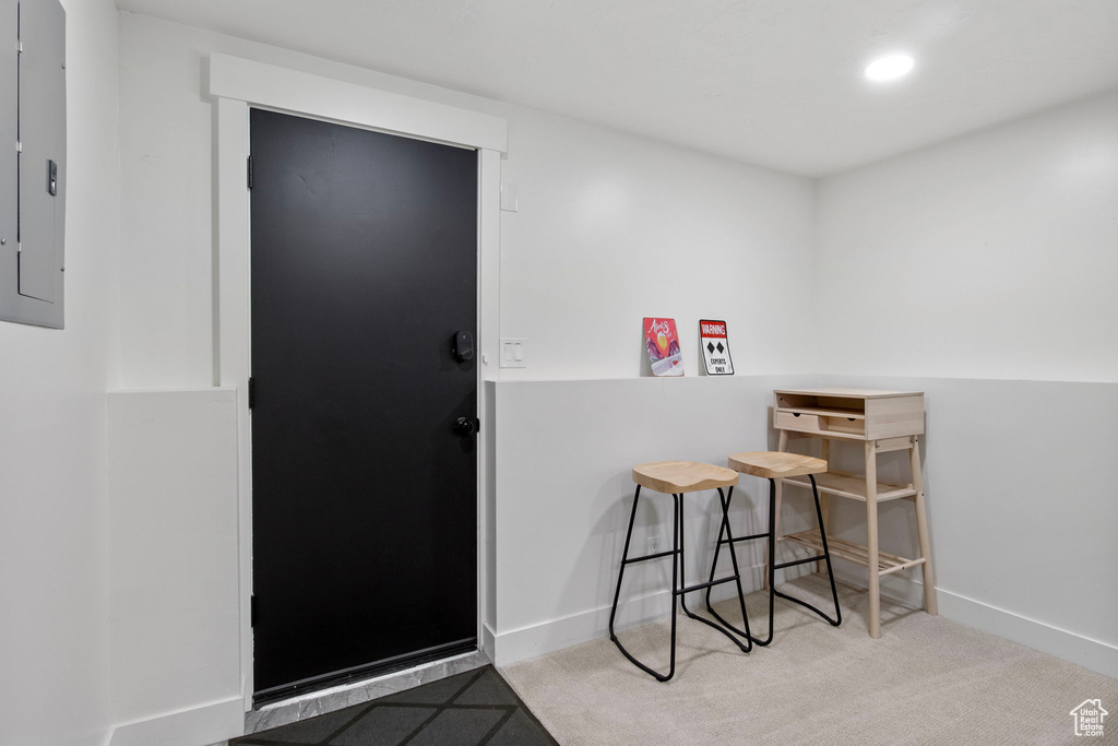 Carpeted entrance foyer with electric panel, recessed lighting, and baseboards