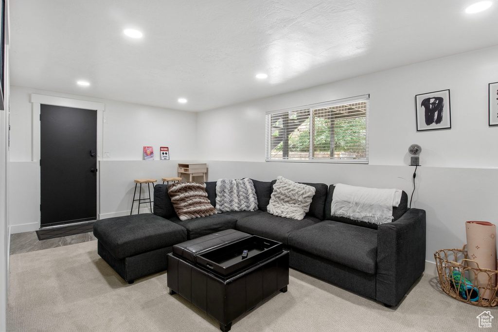 Living room with recessed lighting and light carpet