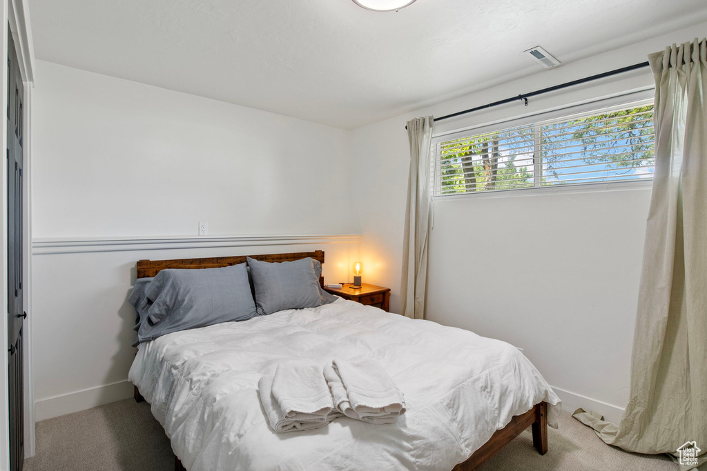 Bedroom featuring carpet flooring and baseboards
