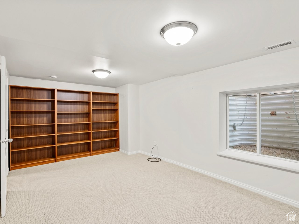 Carpeted empty room with baseboards
