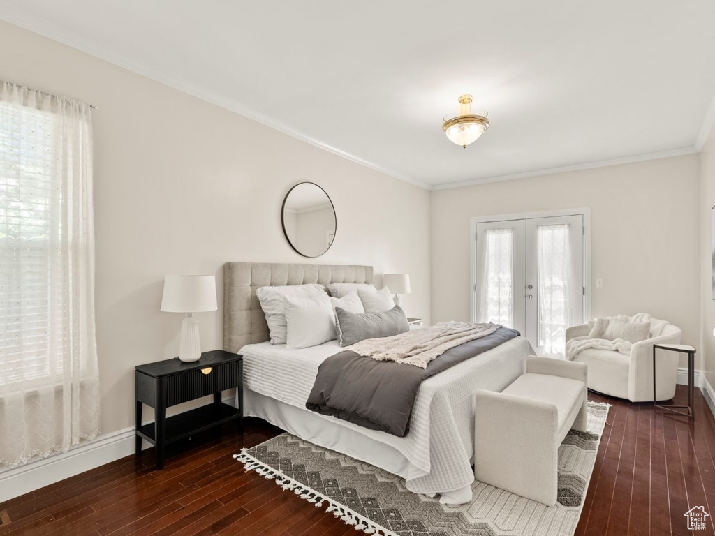 Bedroom featuring dark wood-style flooring, access to exterior, french doors, ornamental molding, and baseboards