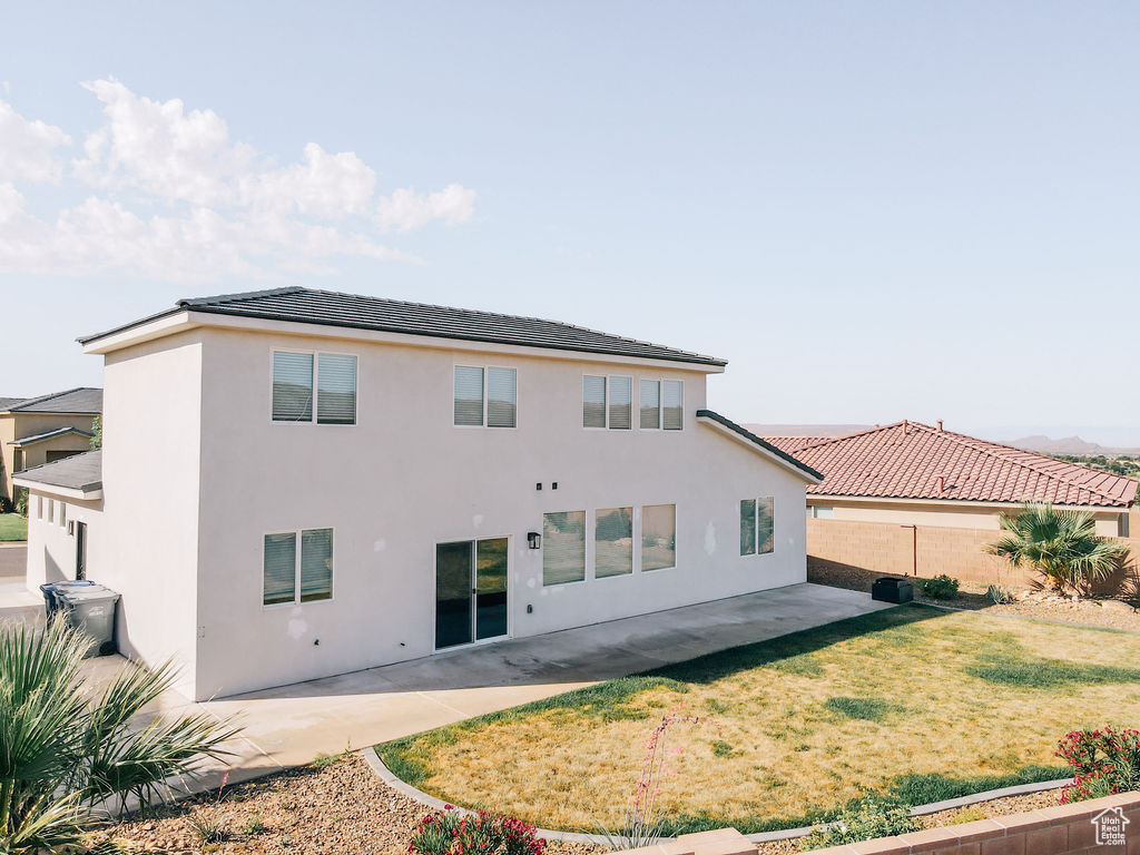 Rear view of property featuring a patio area and stucco siding