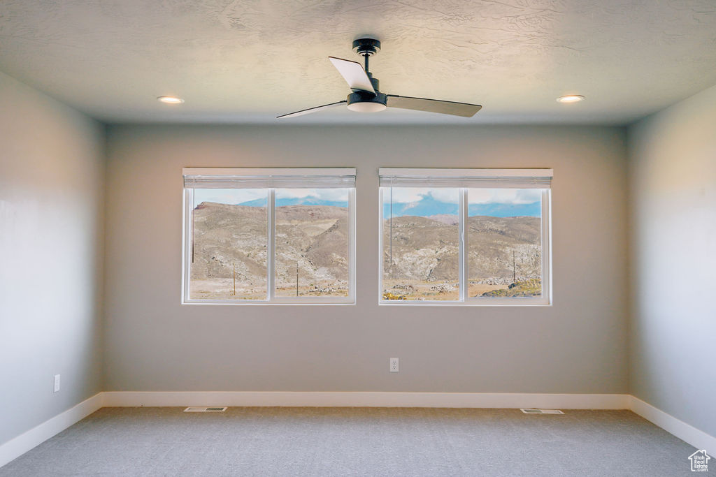 Unfurnished room with light carpet, healthy amount of natural light, a ceiling fan, and recessed lighting