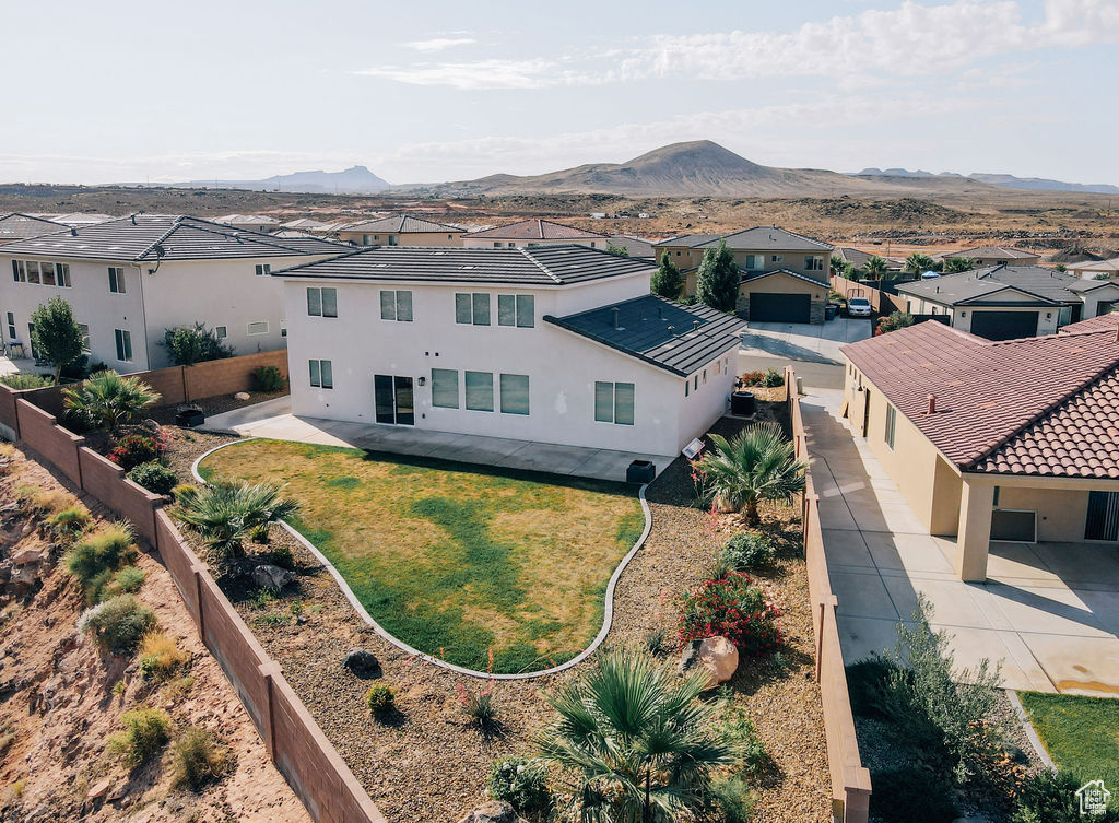 Aerial view of residential area featuring a mountainous background