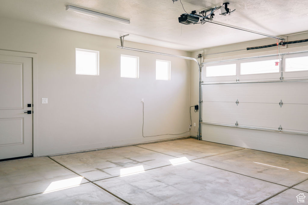 Garage featuring a garage door opener