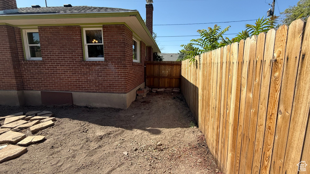 View of side of property featuring brick siding