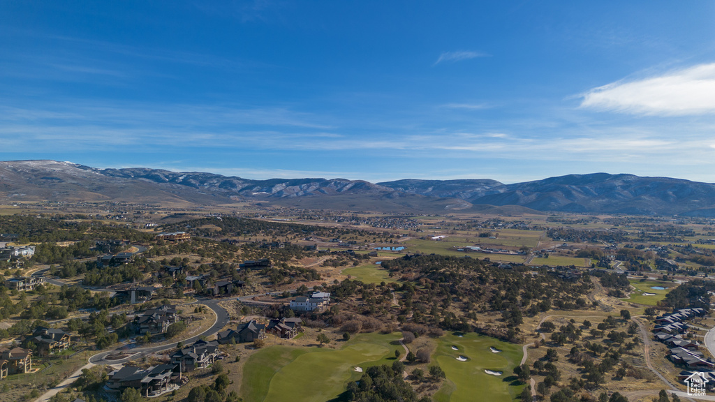 View of mountain background featuring a golf club and nearby suburban area