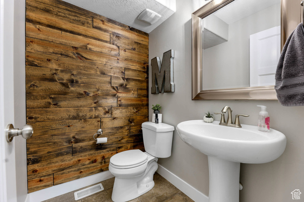 Bathroom with toilet and baseboards