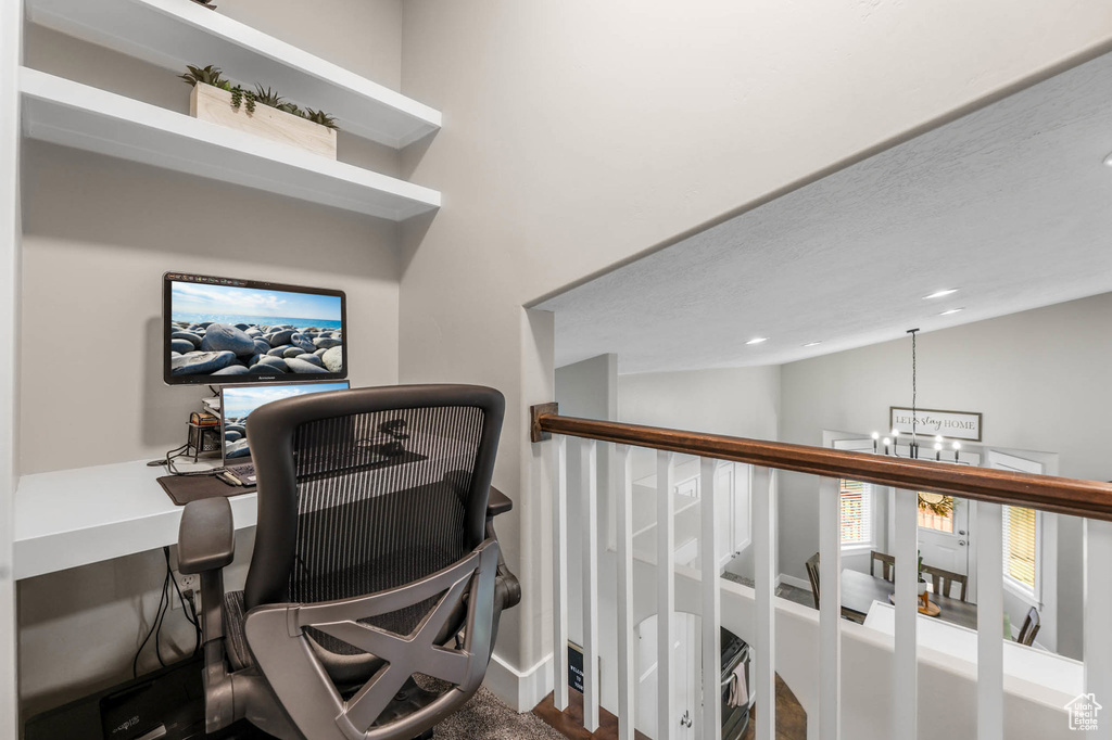 Home office featuring a chandelier, vaulted ceiling, recessed lighting, and baseboards
