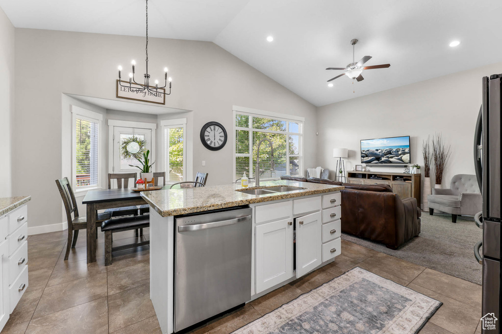 Kitchen with stainless steel appliances, a sink, ceiling fan, white cabinetry, and open floor plan