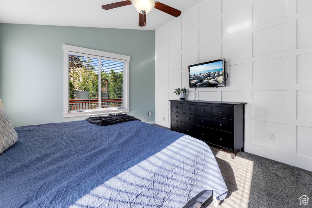 Bedroom with carpet floors, lofted ceiling, and ceiling fan