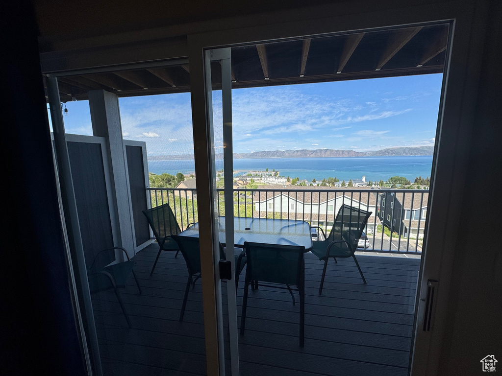 Balcony with a water view and outdoor dining area
