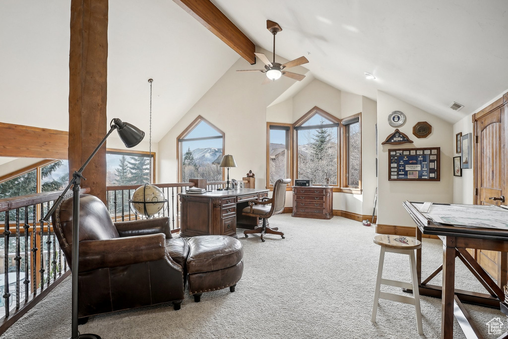 Home office featuring ceiling fan, carpet flooring, plenty of natural light, beamed ceiling, and high vaulted ceiling