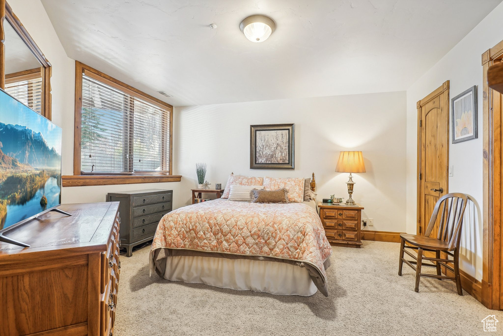 Carpeted bedroom featuring baseboards
