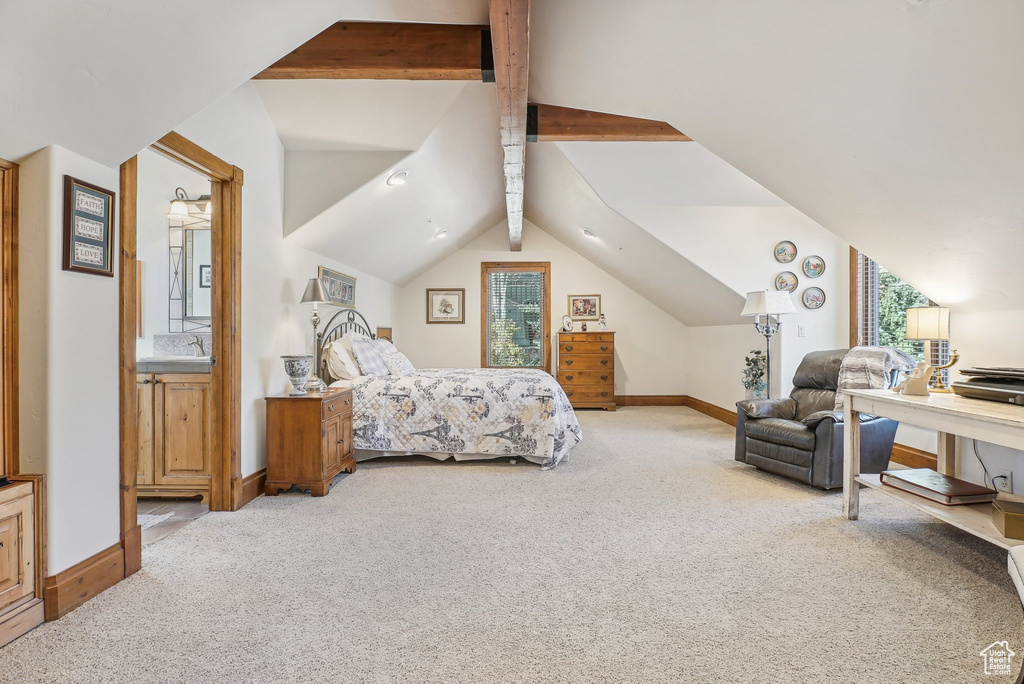 Bedroom featuring carpet, baseboards, ensuite bath, and a sink