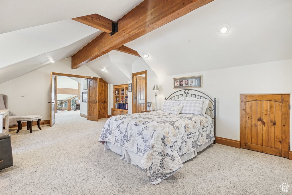 Bedroom featuring carpet and baseboards