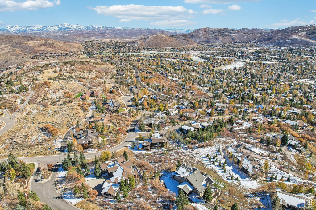 Aerial overview of property\'s location with a mountain backdrop and nearby suburban area