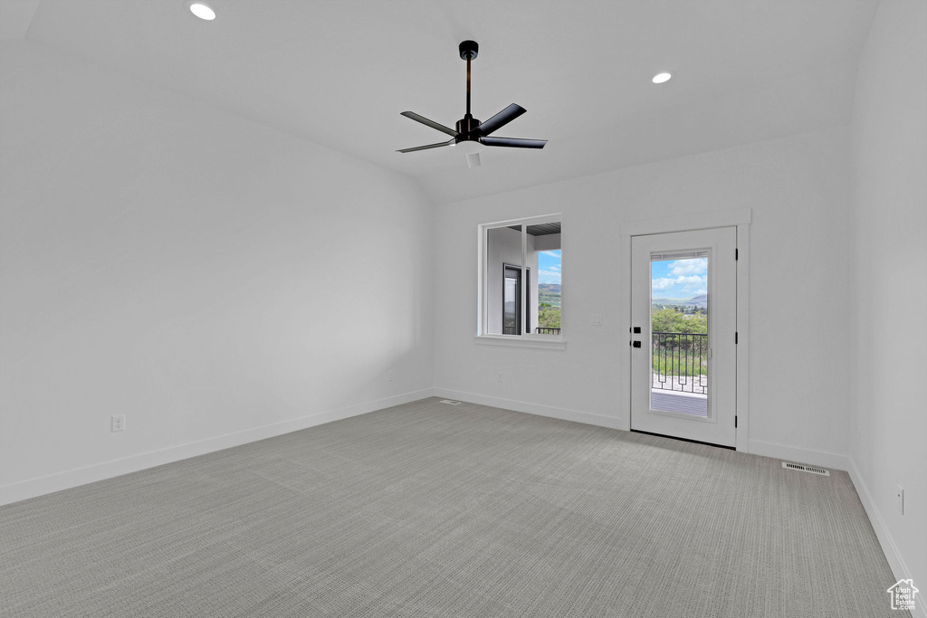 Carpeted empty room with a ceiling fan, recessed lighting, and baseboards